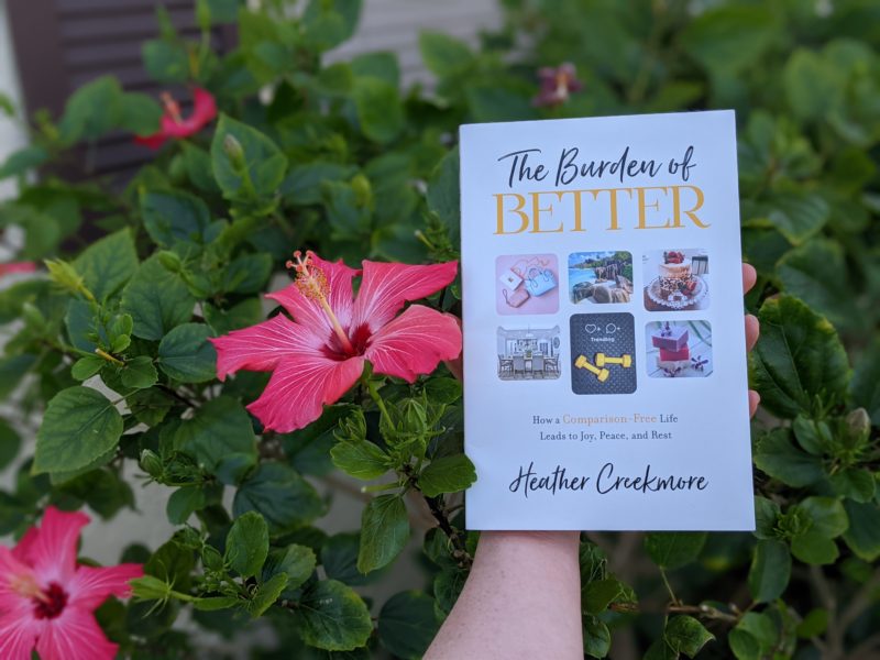 The best books about food and faith Erin holding her pick for the best body image books The Burden of Better by Heather Creekmore